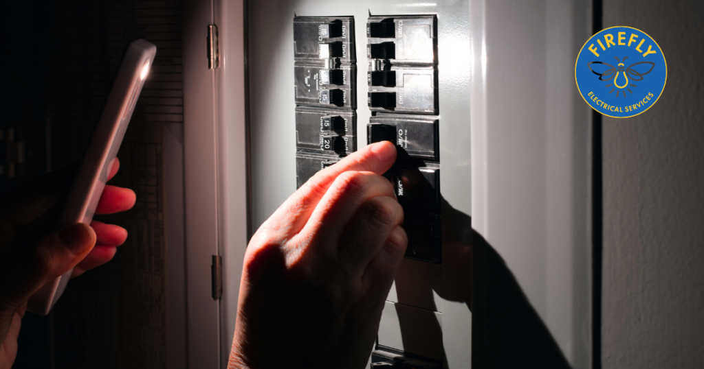 A homeowner looking at their electrical panel from Firefly Electrical